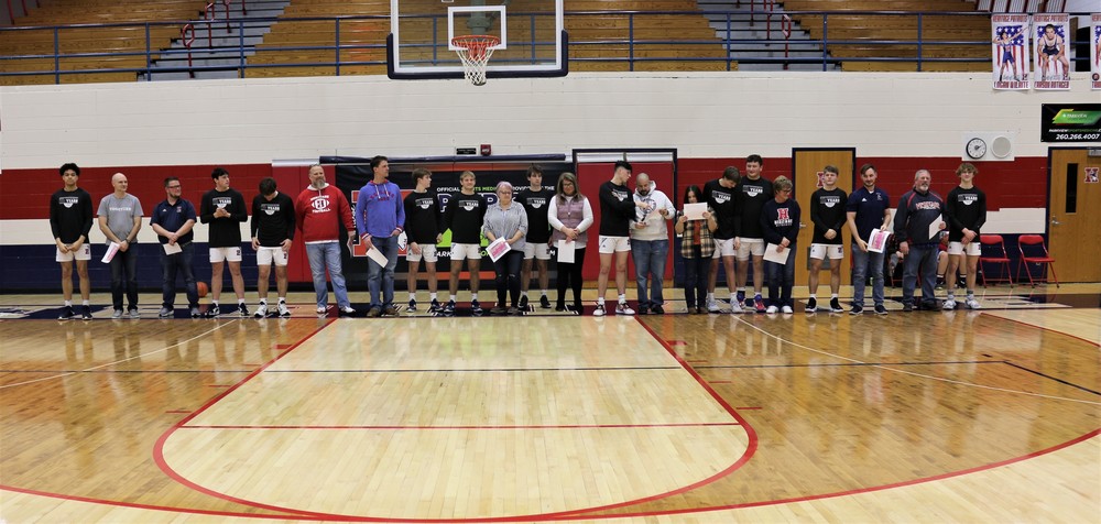 On Teacher Appreciation Night, Heritage varsity basketball players stand with  some of their favorite teachers , as the teachers are honored for the roles they play in the student-athletes' lives.